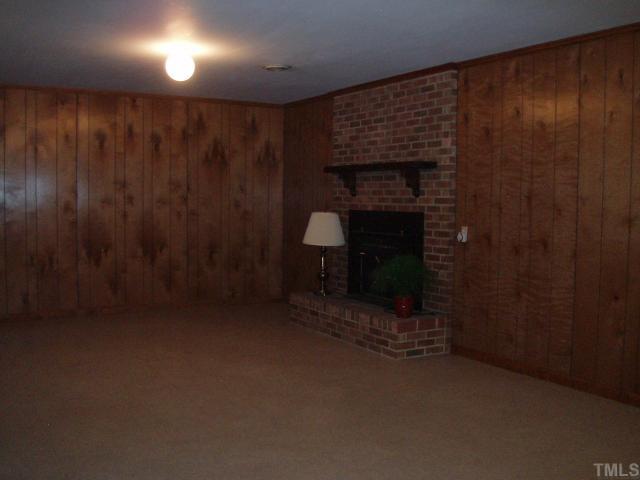 4923 Oak Park Road Raleigh, NC 27612 - Photo 8 of 12 30x13.5....Huge room with 2nd fireplace (has wood stove insert). Walk-out patio doors on opposite end of room exits to deck with built-in seating and fenced back yard.
