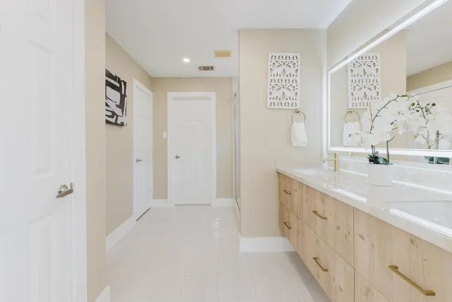 a bathroom with a double vanity sink and mirror
