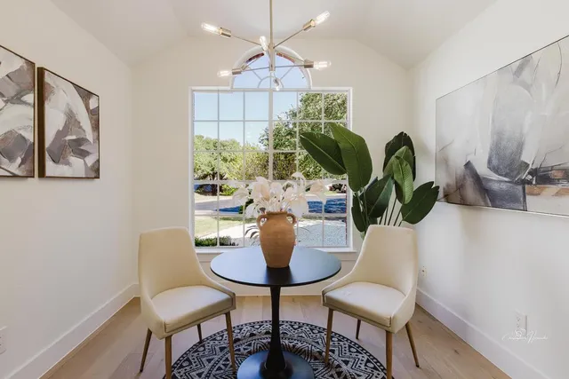a dining room with furniture and a potted plant