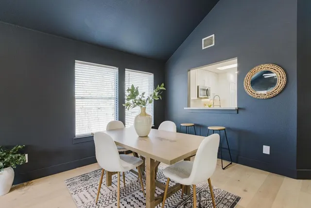 a dining room with furniture and window