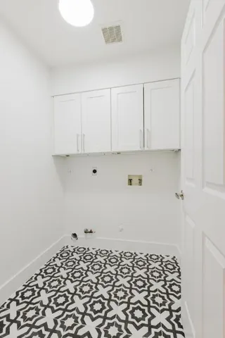 a room with a white cabinet and a stove