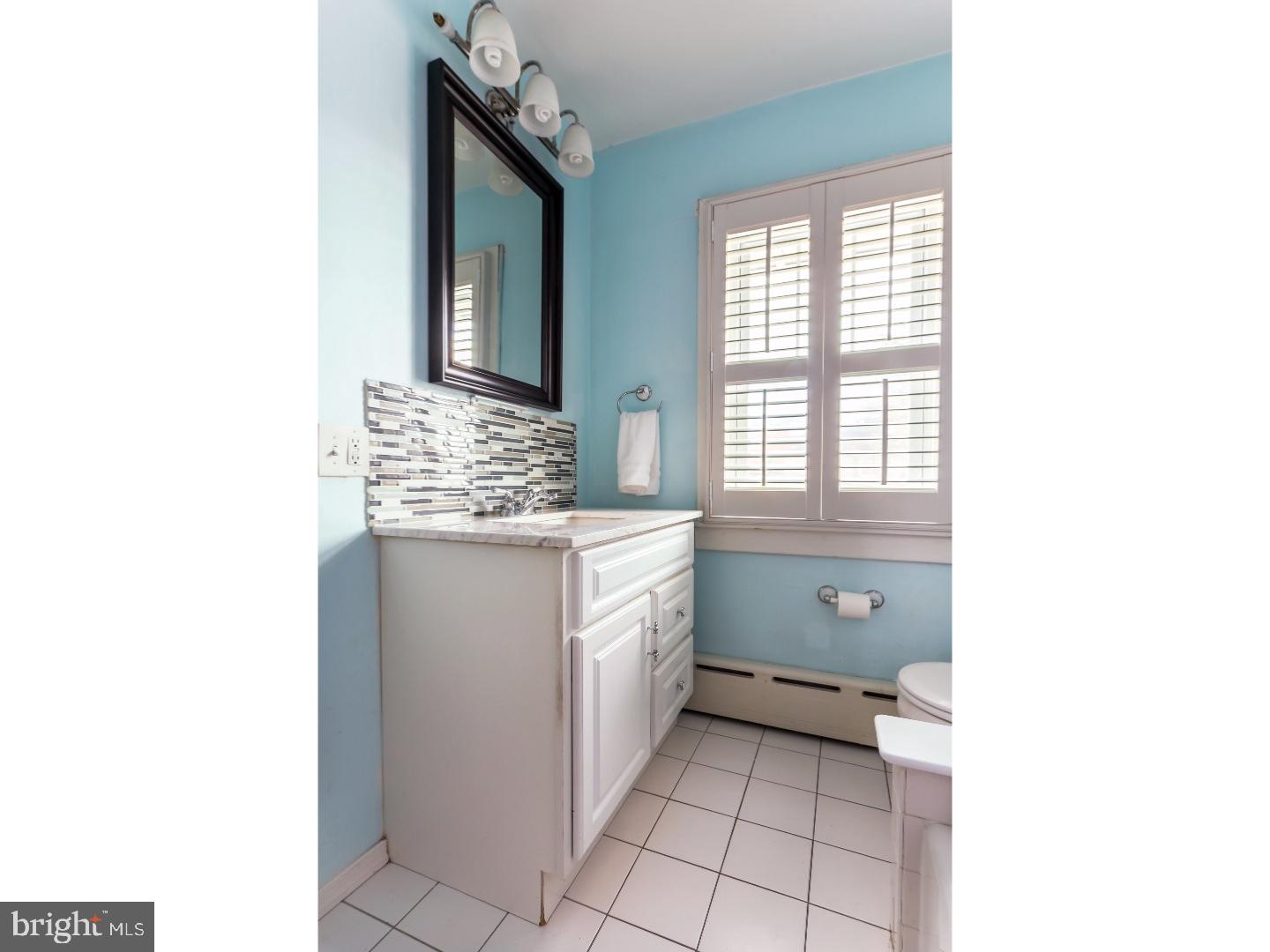 519 East Manoa Road Havertown, PA 19083 - Photo 16 of 20 a bathroom with a sink a toilet and mirror