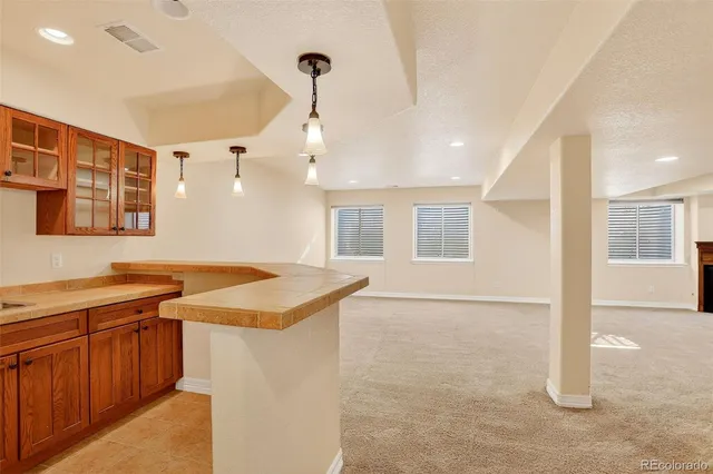 a kitchen that has a sink a stove and a window