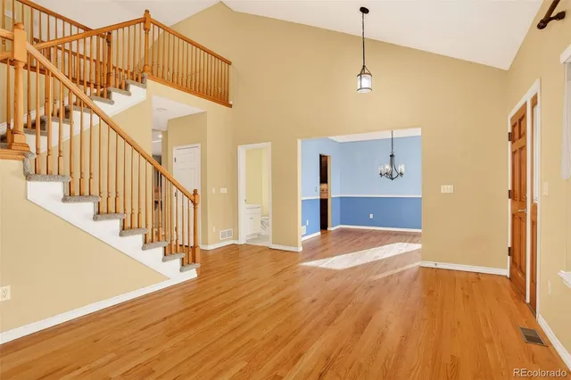 a view of a room with wooden floor and staircase