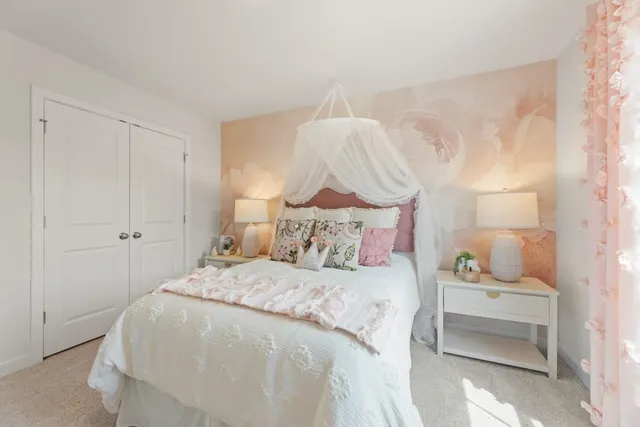 a bedroom with a bed and a lamp