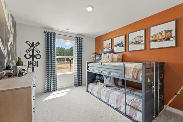 a bed room with a bed and a chair