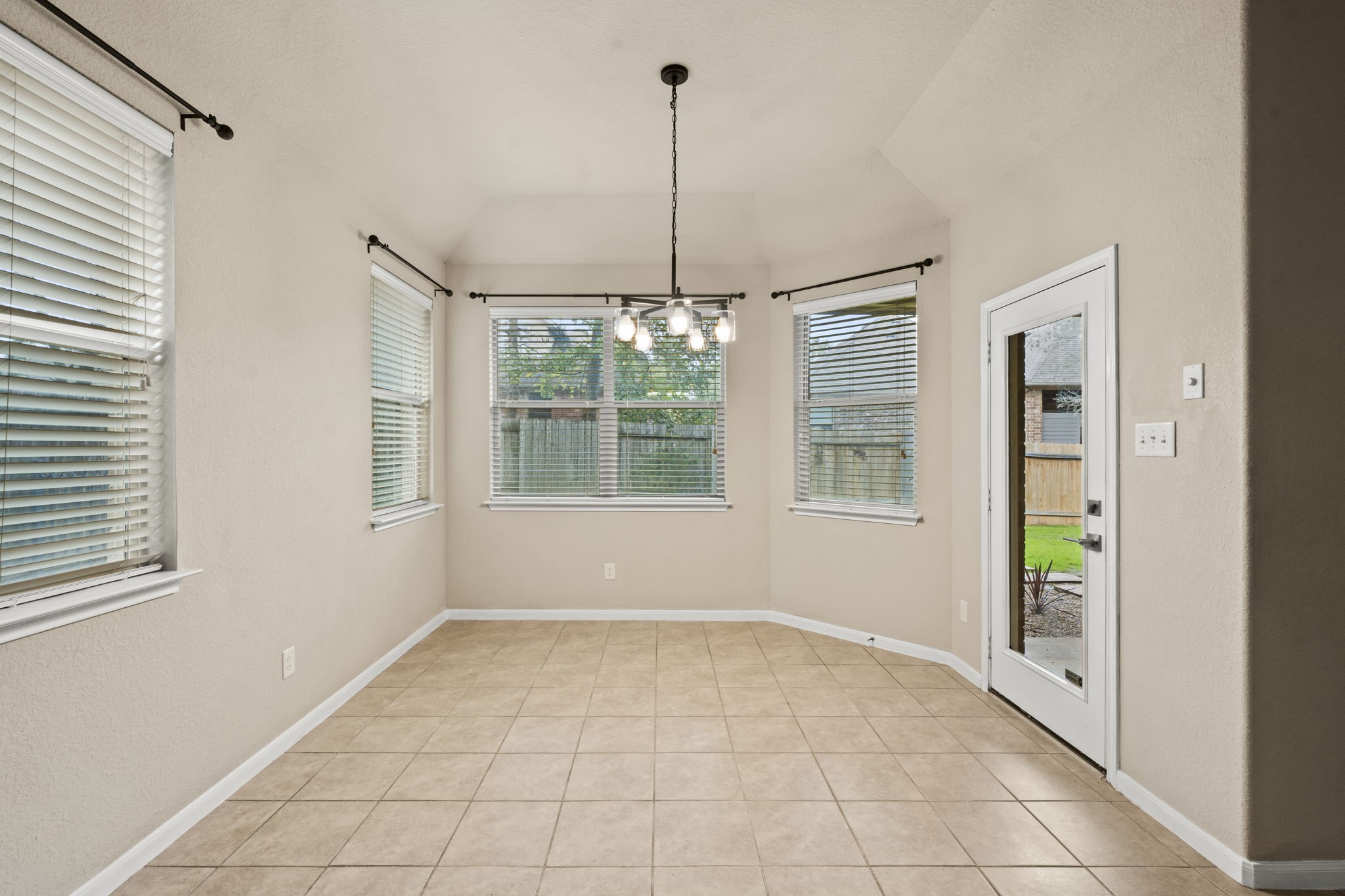 1906 Pagemill Lane Conroe, TX 77304 - Photo 18 of 41 a view of an empty room with windows and cabinet