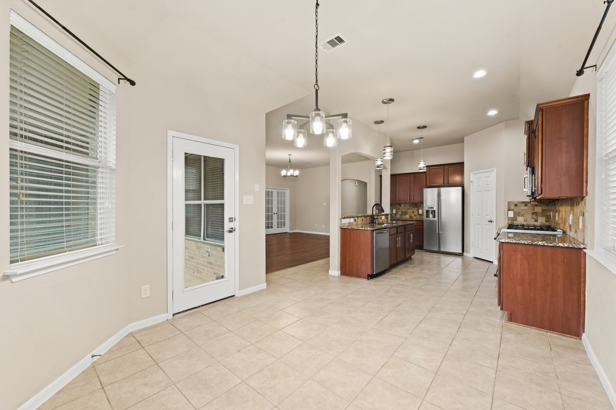1906 Pagemill Lane Conroe, TX 77304 - Photo 19 of 41 a kitchen with stainless steel appliances a refrigerator and a sink