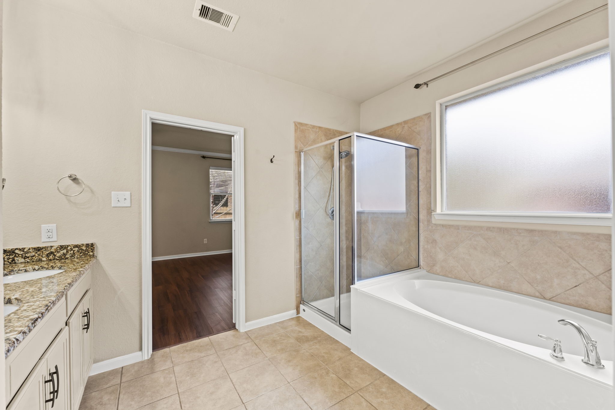1906 Pagemill Lane Conroe, TX 77304 - Photo 26 of 41 a bathroom with a bathtub and a shower