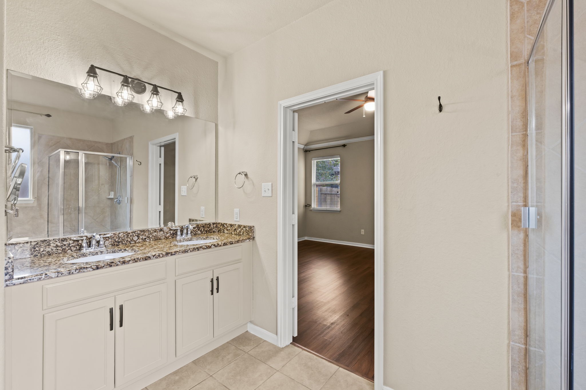 1906 Pagemill Lane Conroe, TX 77304 - Photo 27 of 41 a en suite bathroom with a granite countertop sink and a mirror
