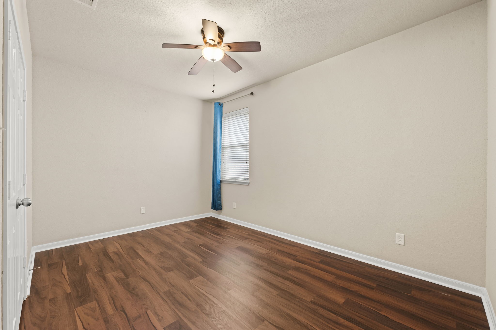 1906 Pagemill Lane Conroe, TX 77304 - Photo 32 of 41 a view of room with hardwood floor and ceiling fan