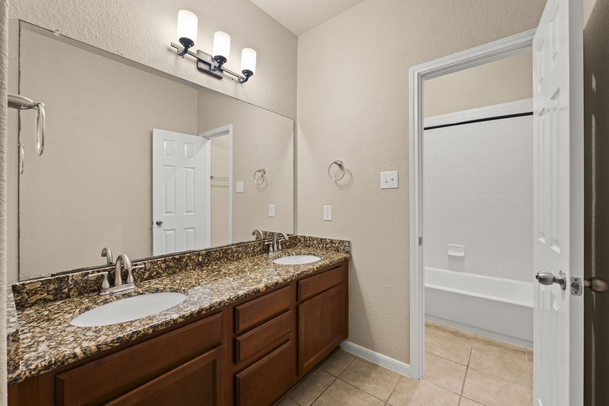 1906 Pagemill Lane Conroe, TX 77304 - Photo 34 of 41 a bathroom with a granite countertop sink and a mirror