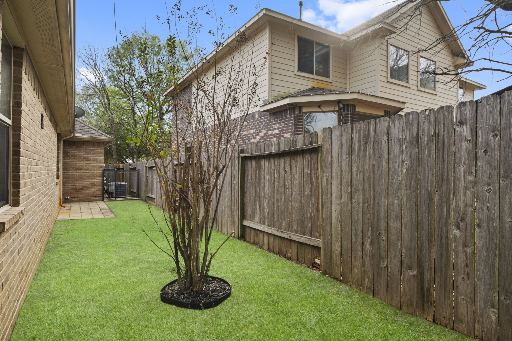 1906 Pagemill Lane Conroe, TX 77304 - Photo 40 of 41 a view of a house with brick walls and a table in a yard