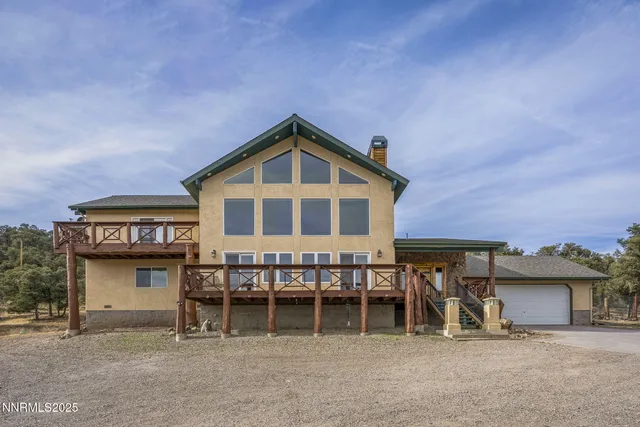 a view of a house with a yard and balcony