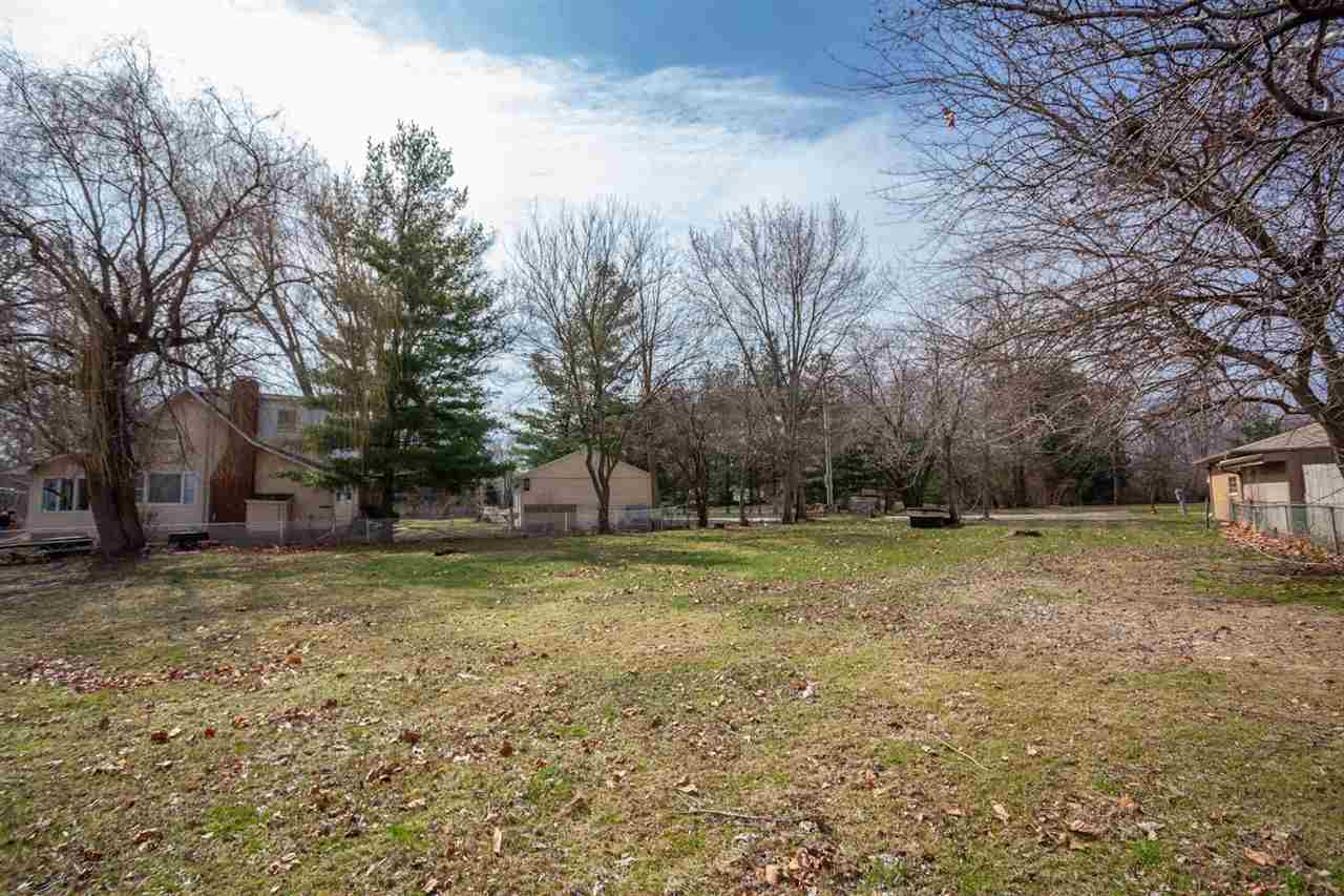 5065 Browns Beach Road Rockford, IL 61103 - Photo 5 of 9 a view of a yard with a tree
