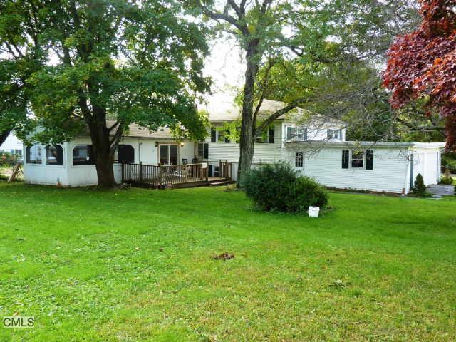 a view of a house with a backyard porch and sitting area