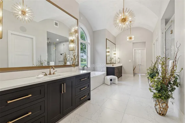 a spacious bathroom with a double vanity sink and a mirror