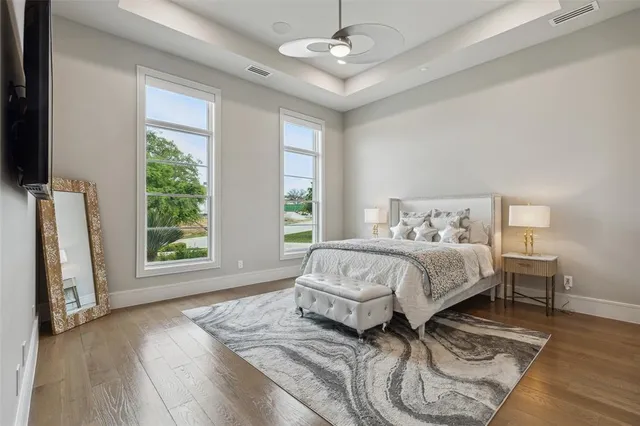 a spacious bedroom with a bed and a large window