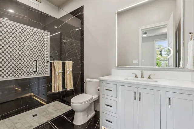 a bathroom with a sink toilet and shower