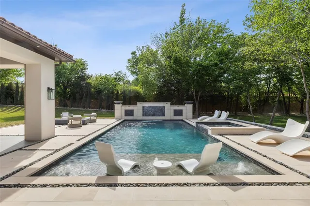 a view of a backyard with couches chair and a fire pit
