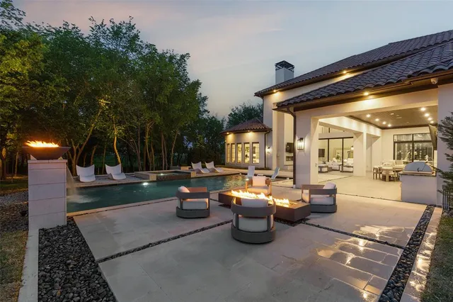 a outdoor space with patio fireplace and a potted plant