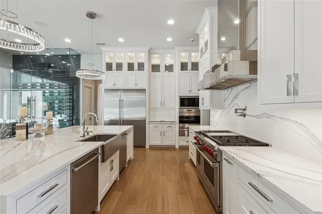 a kitchen with stainless steel appliances granite countertop a stove and a sink