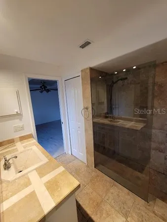 a bathroom with a shower and a sink