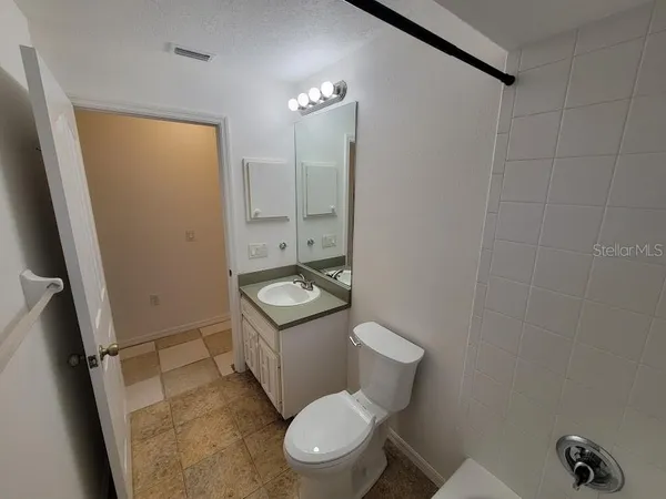 a white toilet sitting next to a bathroom sink