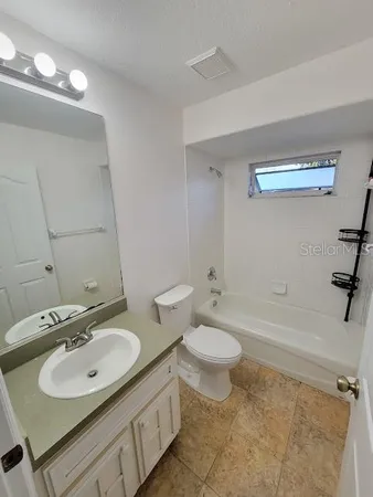 a bathroom with a sink toilet a mirror and shower