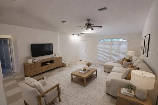 a living room with furniture and a flat screen tv