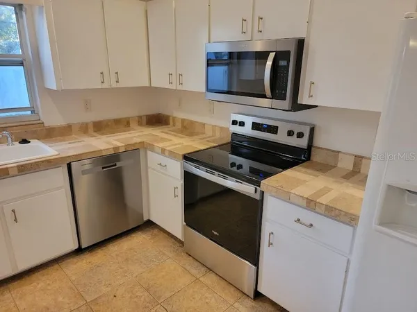 a kitchen with a stove and a microwave