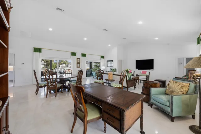 a living room with furniture a rug and a flat screen tv