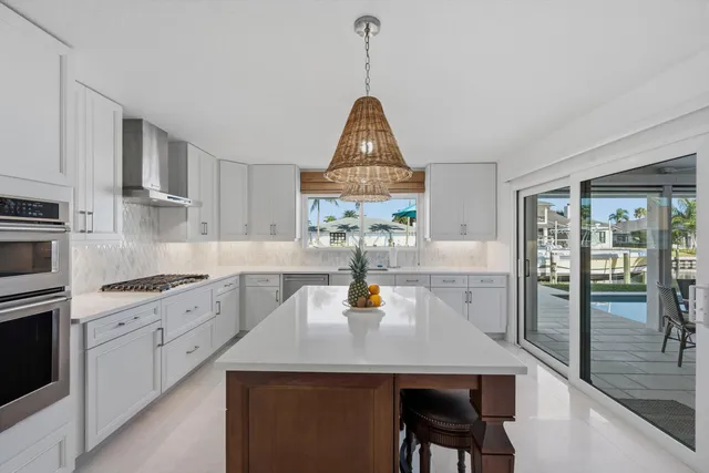 a kitchen with a sink a stove and chairs