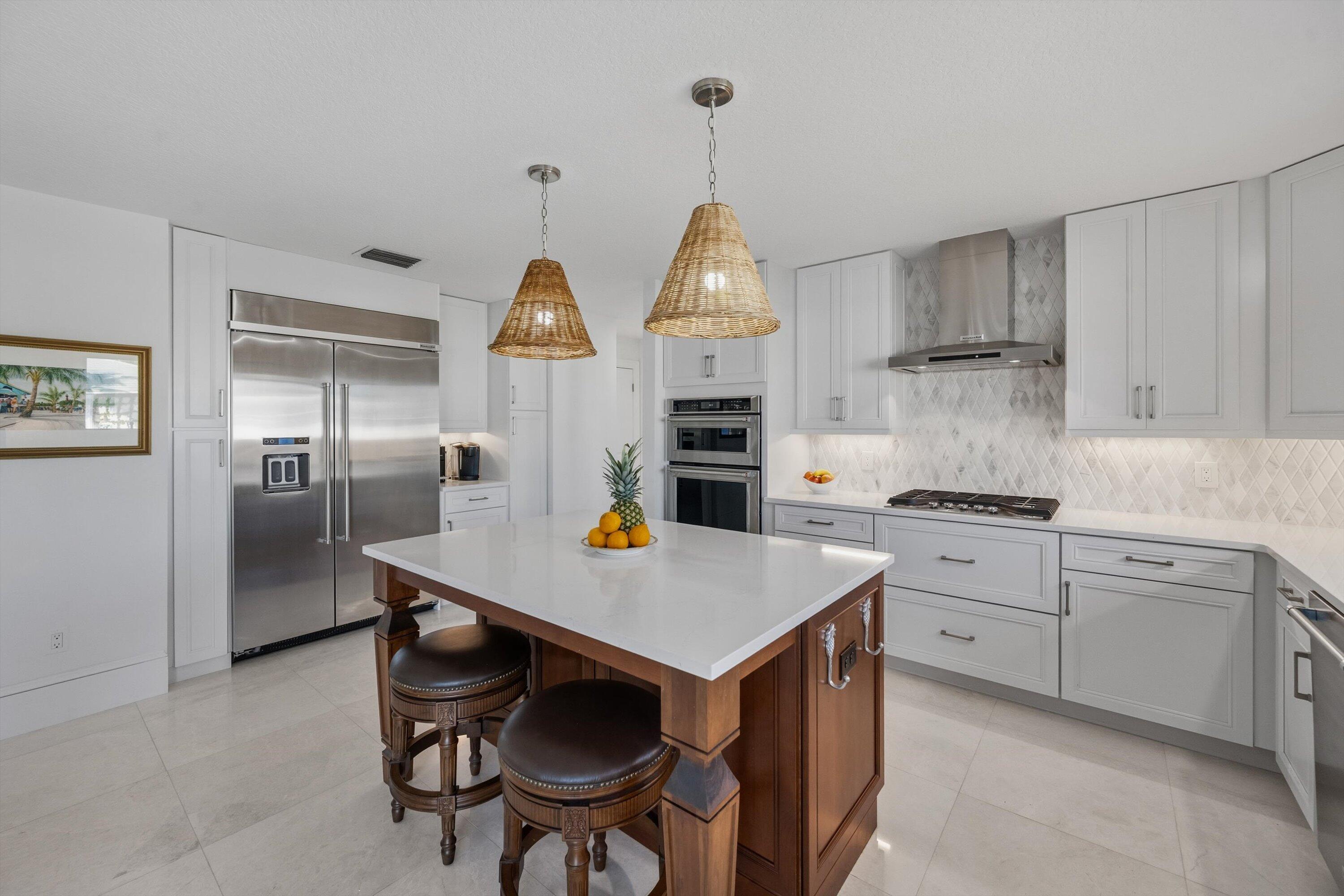 9039 Southeast Hawksbill Way Hobe Sound, FL 33455 - Photo 19 of 45 a kitchen with stainless steel appliances a sink stove and refrigerator