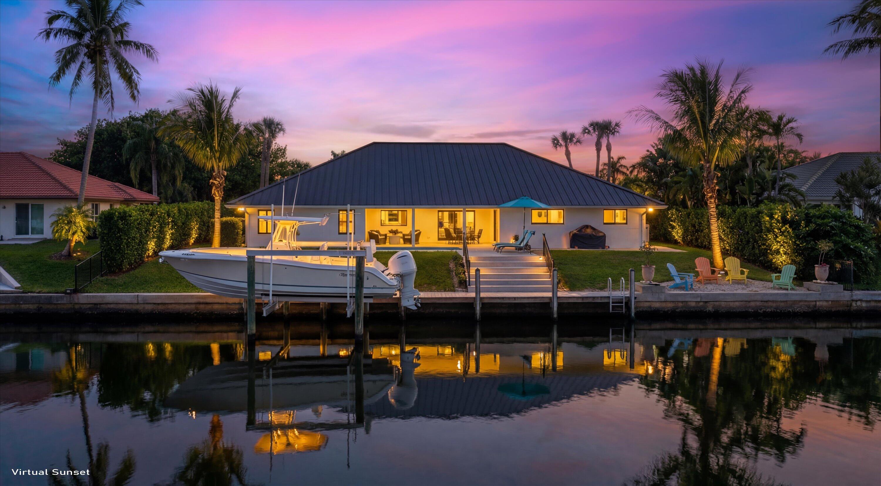 9039 Southeast Hawksbill Way Hobe Sound, FL 33455 - Photo 2 of 45 a view of a house with a swimming pool and sitting area