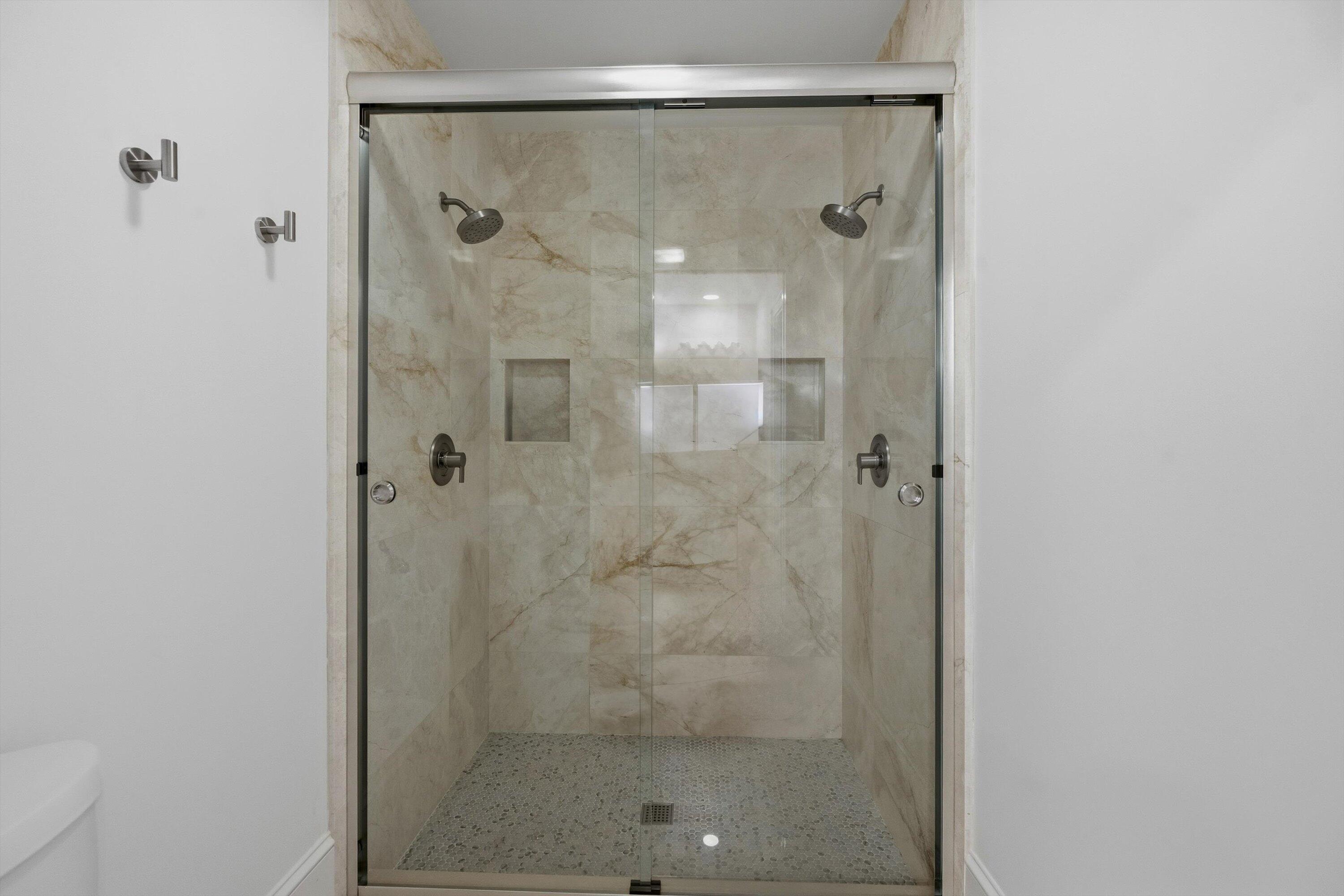 9039 Southeast Hawksbill Way Hobe Sound, FL 33455 - Photo 24 of 45 a bathroom with a glass shower door