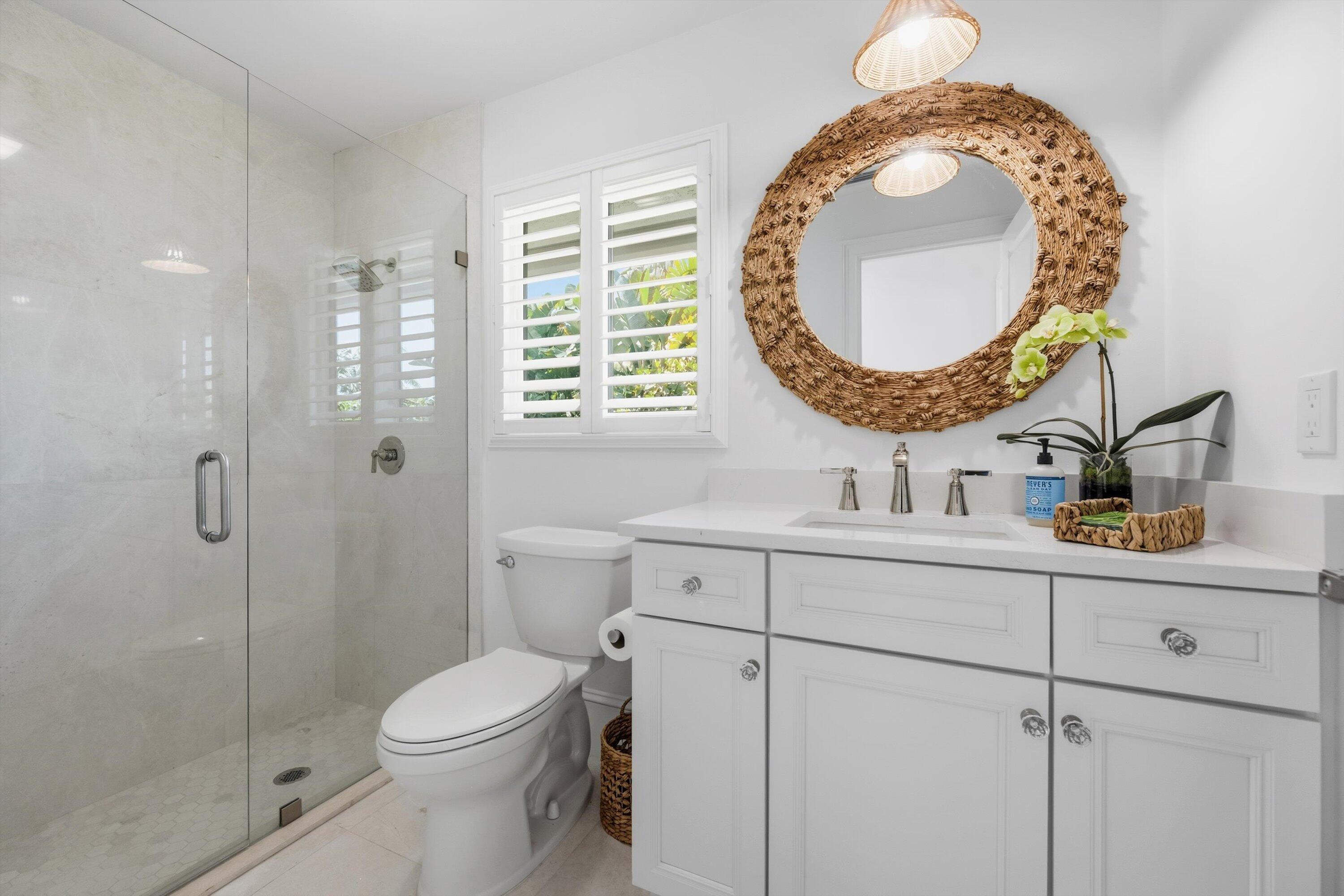 9039 Southeast Hawksbill Way Hobe Sound, FL 33455 - Photo 28 of 45 a bathroom with a toilet a sink and mirror