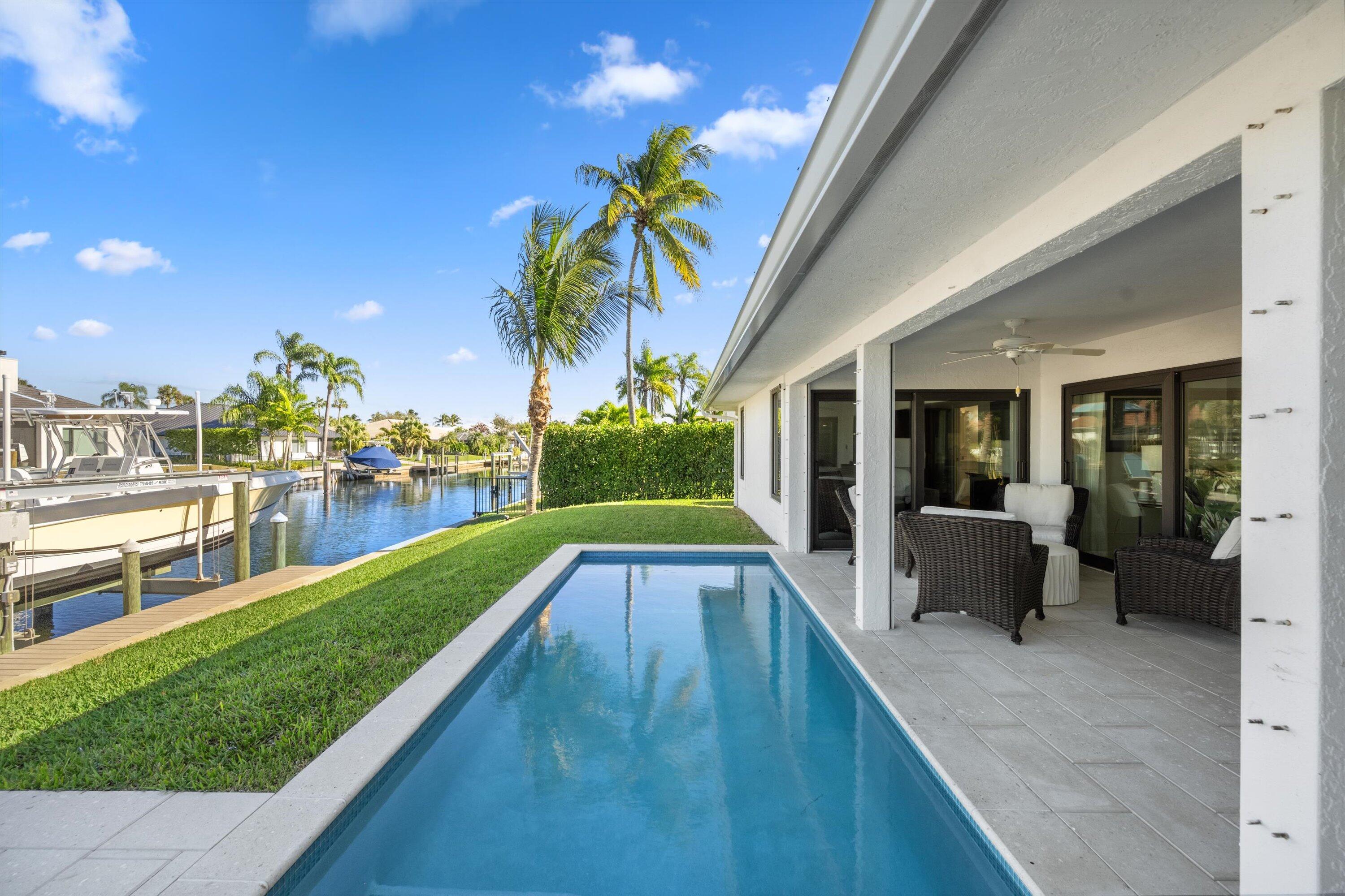 9039 Southeast Hawksbill Way Hobe Sound, FL 33455 - Photo 33 of 45 a view of swimming pool with a patio and a yard