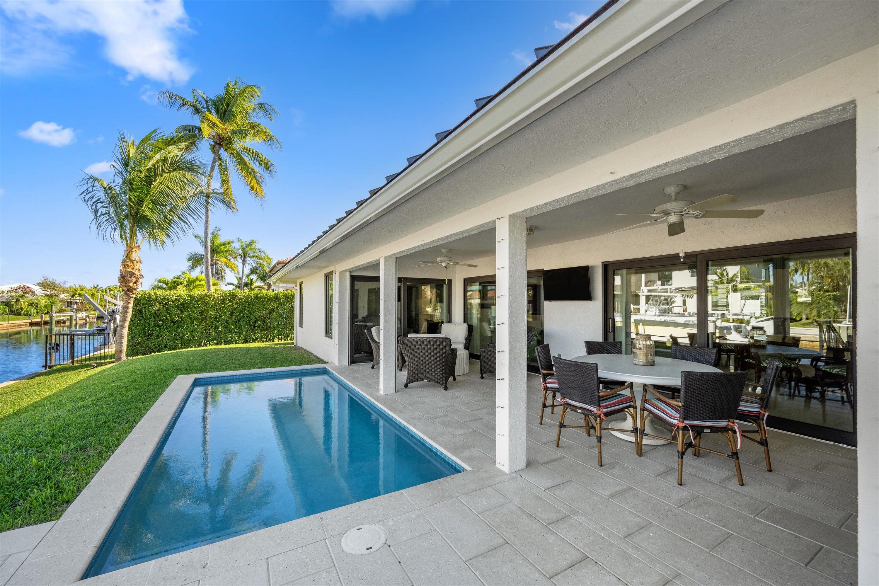 9039 Southeast Hawksbill Way Hobe Sound, FL 33455 - Photo 34 of 45 a view of a house with swimming pool and sitting area