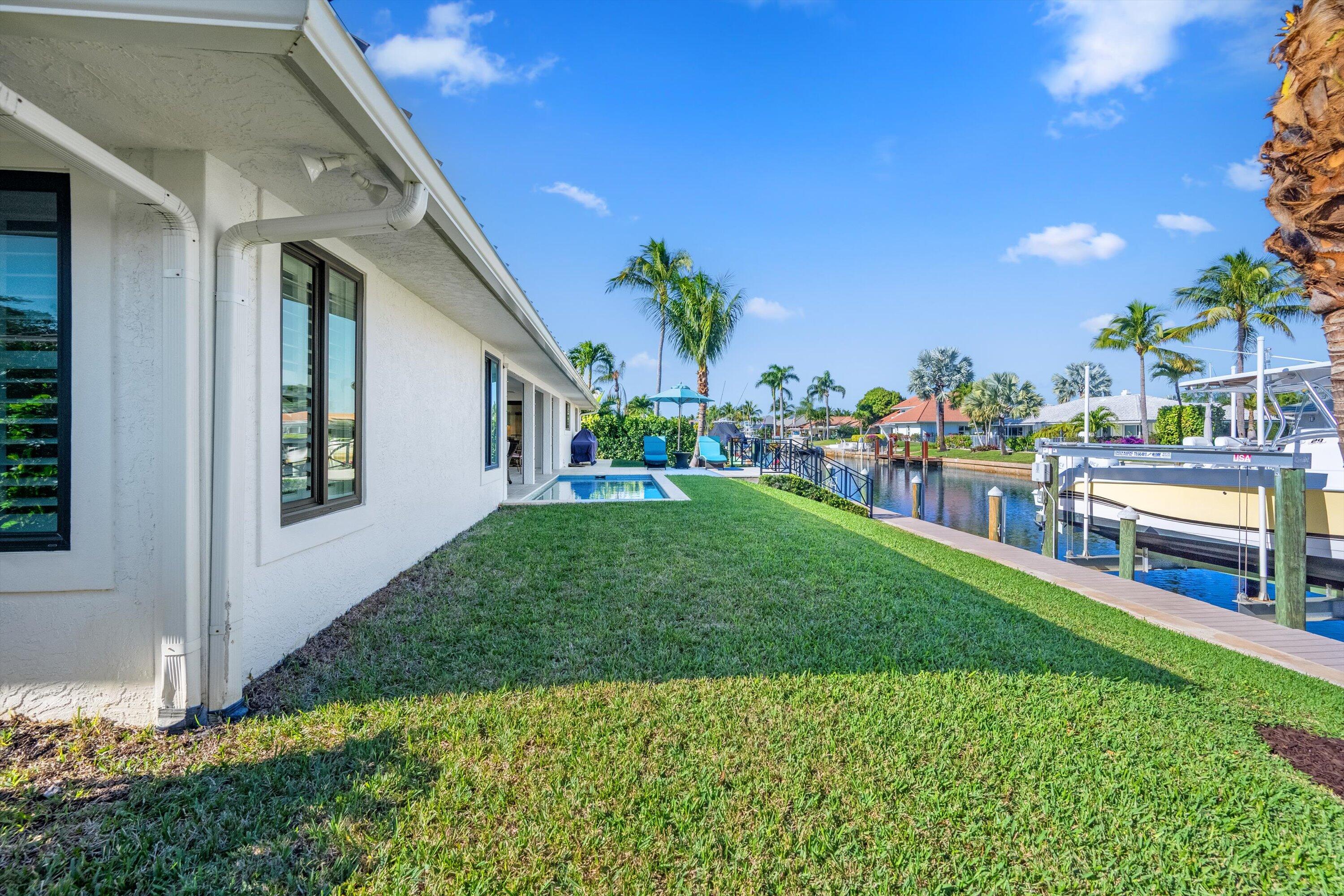 9039 Southeast Hawksbill Way Hobe Sound, FL 33455 - Photo 35 of 45 a view of a house with a backyard