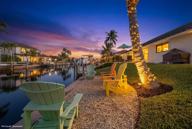 a view of a chairs and table in backyard