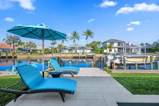 a view of a swimming pool with outdoor seating space