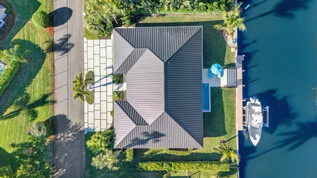 an aerial view of a house with a yard and potted plants