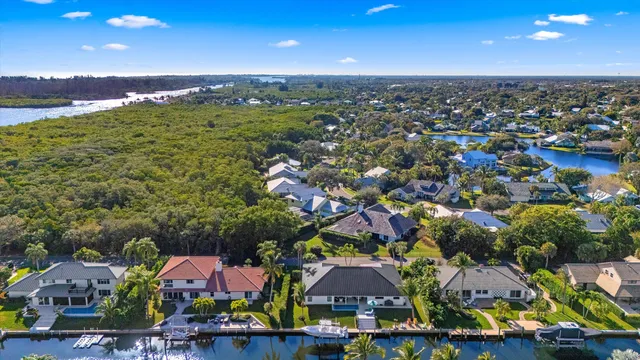 an aerial view of residential houses with outdoor space and parking