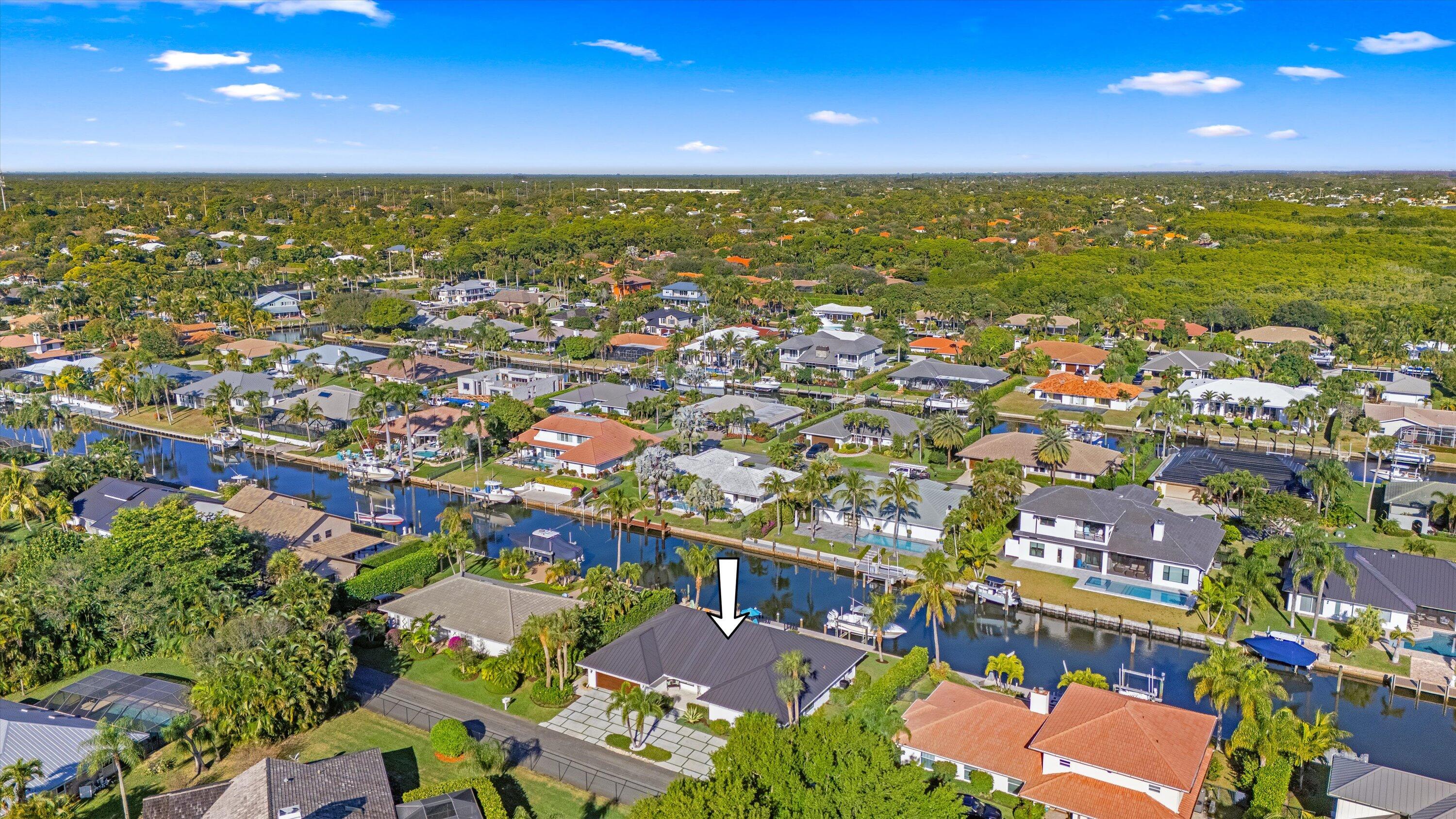 9039 Southeast Hawksbill Way Hobe Sound, FL 33455 - Photo 43 of 45 an aerial view of residential houses with outdoor space and swimming pool