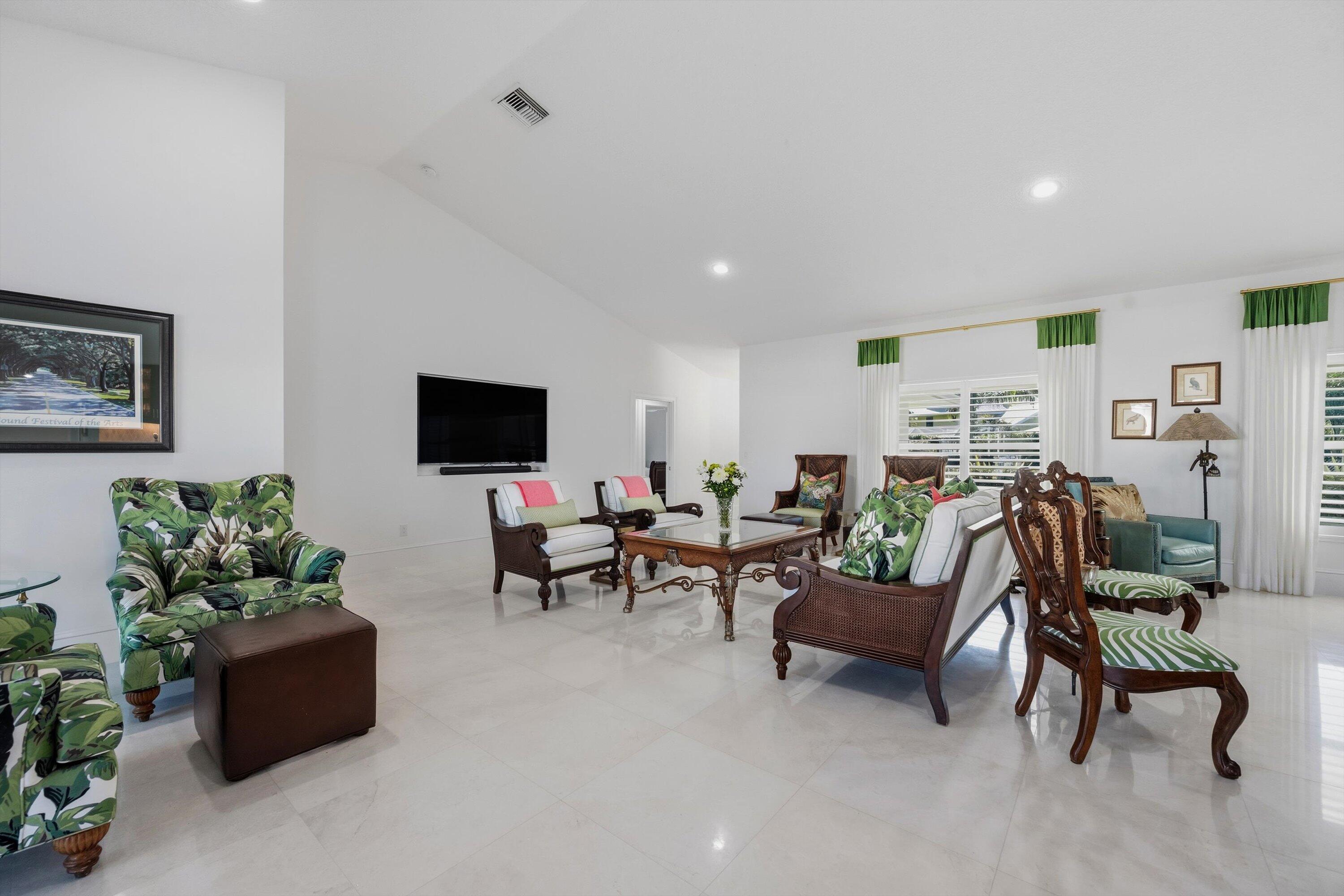 9039 Southeast Hawksbill Way Hobe Sound, FL 33455 - Photo 10 of 45 a living room with furniture and a flat screen tv