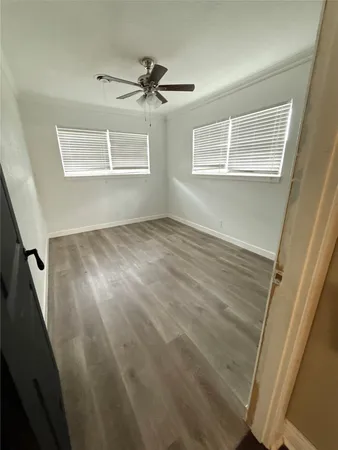 a view of an empty room and wooden floor