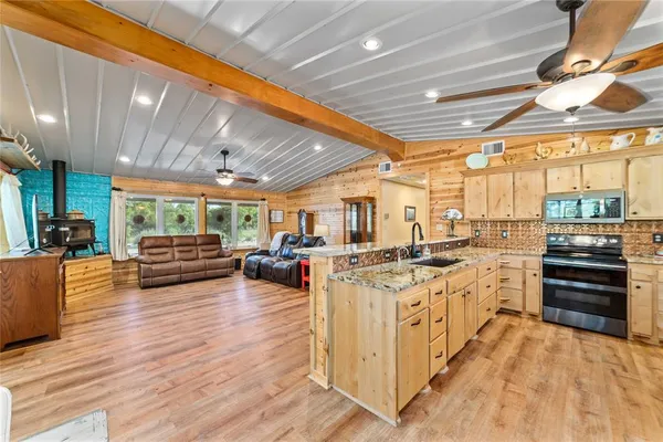 a kitchen with lots of counter top space and wooden floor