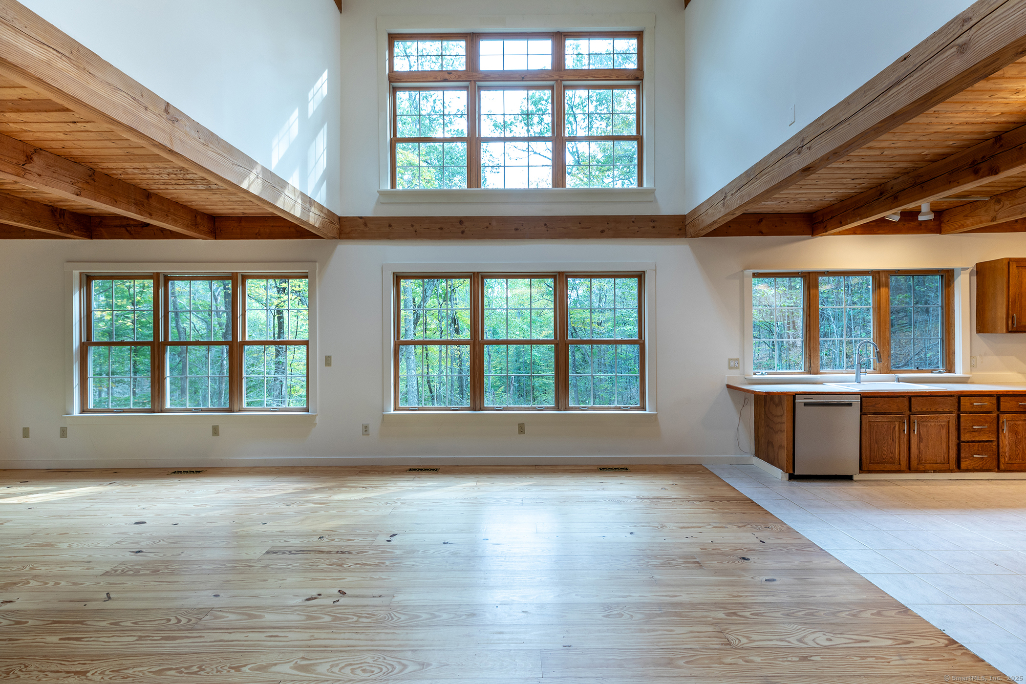 38 West Mountain Lane Roxbury, CT 06783 - Photo 7 of 26 an empty room with wooden floor and windows
