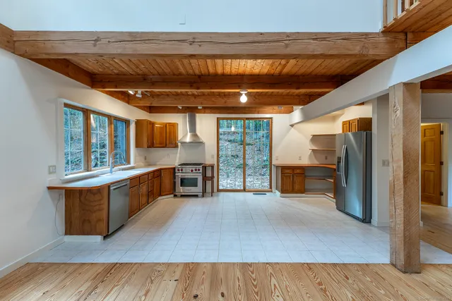 a view of kitchen with granite countertop window and refrigerator